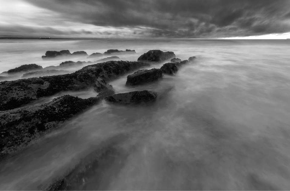 What lies beneath and beyond is left to the imagination as the sea courses its way over lines of rock, Mossel Bay.