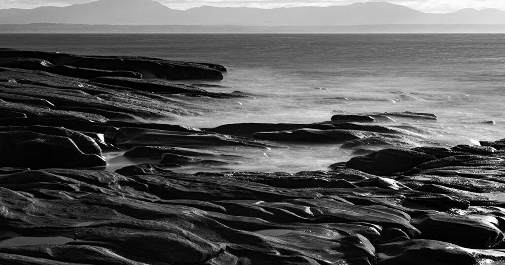 Saltwater glistens on the polished rocks of Mossel Bay.