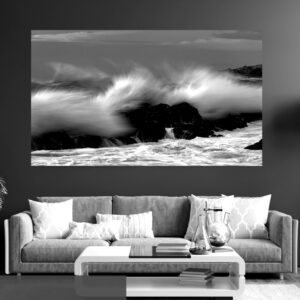 A wave crests the rocks at The Point, Mossel Bay, creating the illusion of a mohawk emerging from stone.