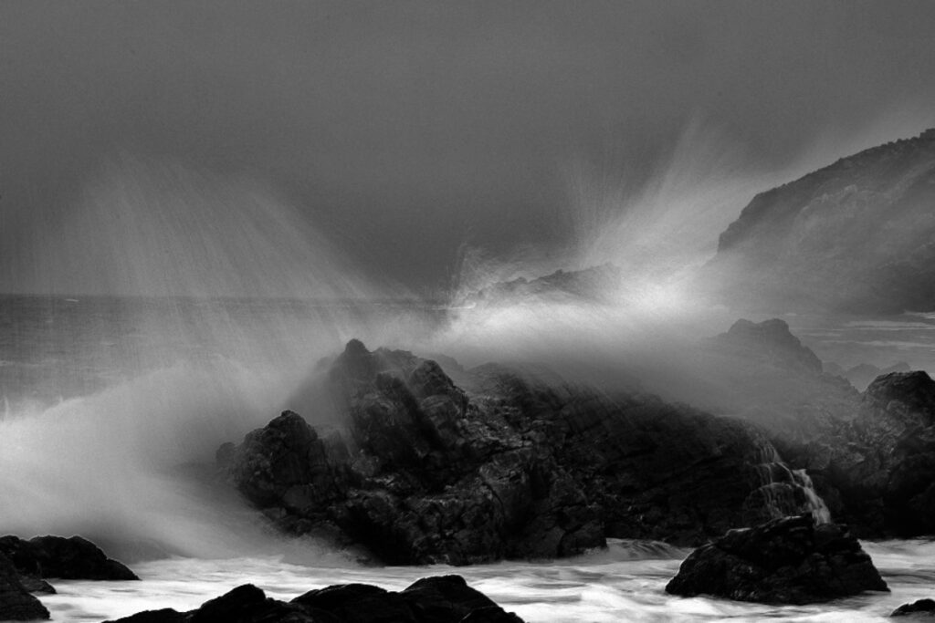 Waves create a graceful spray on the rocky outcrops of The Point, Mossel Bay.