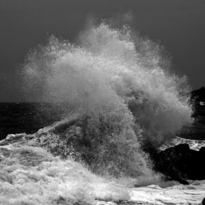 Open ocean waves crash and foam over the rocky coastline at The Point, Mossel Bay.