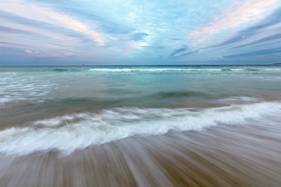 Waves gently rolling into Santos Beach on a chilly morning.