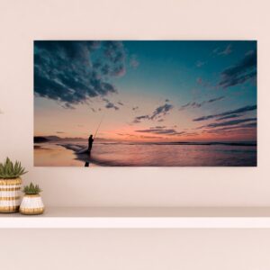 A fisherman posted on Hartenbos beach in a moment of solitude at dawn.