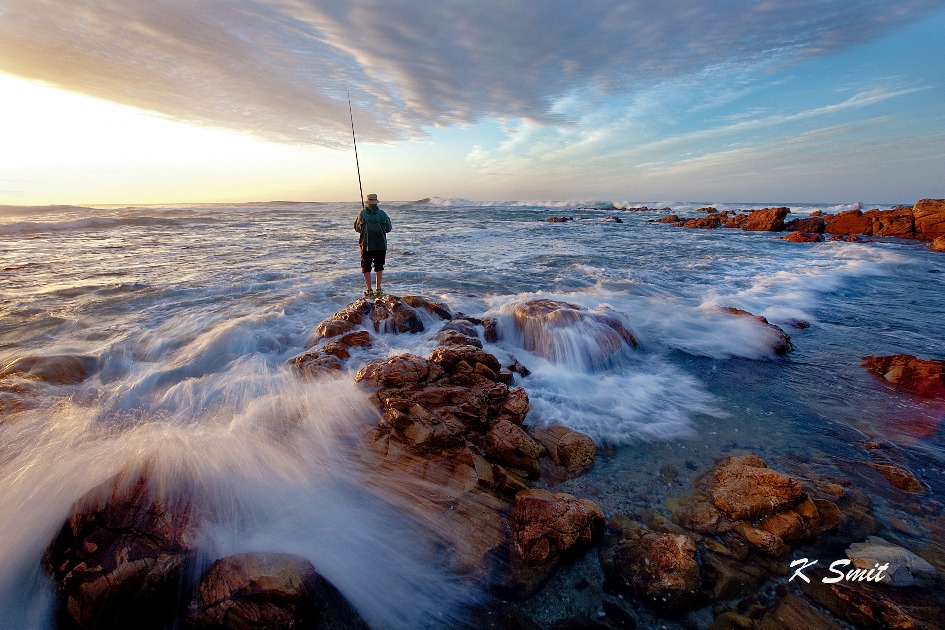 A fisherman finds some early morning action on the rocks at The Point, Mossel Bay.