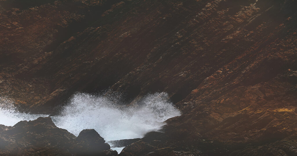 Water meets stone at the jagged coastline of The Point, Mossel Bay.