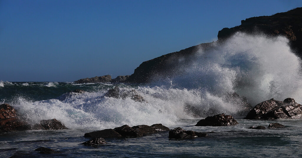 Waves pound mercilessly on a stormy day, The Point, Mossel Bay.
